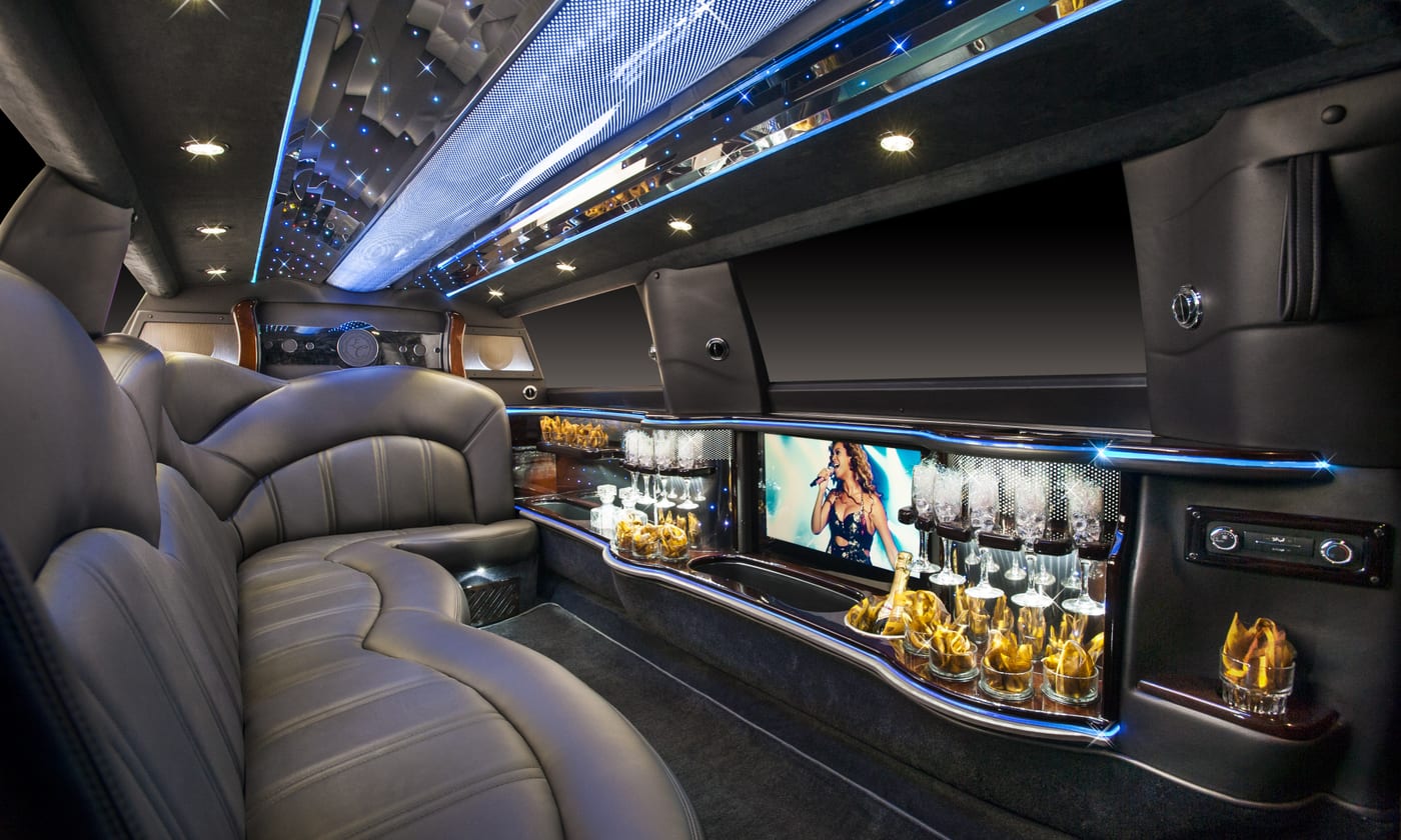 Lincoln MKT stretch limousine interior with a fiber-optic starlight ceiling, mirrored wet bar and flat-screen entertainment display