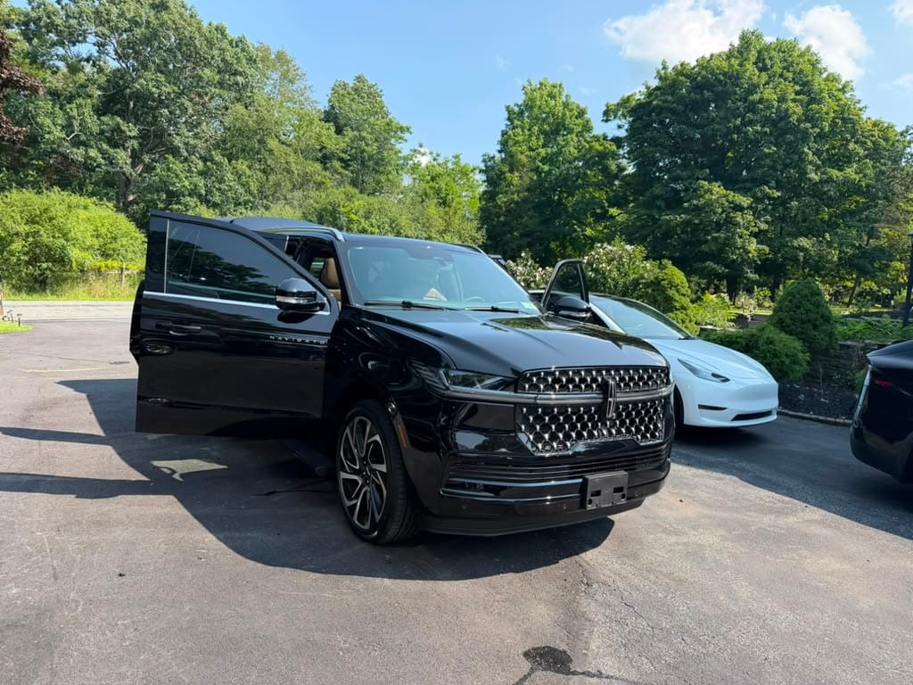Lincoln Navigator SUV limo (black), front three-quarter exterior view