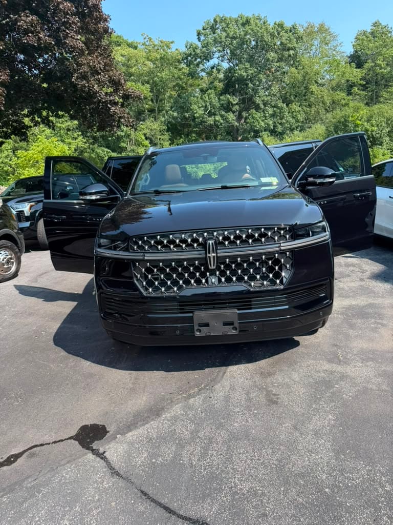 Lincoln Navigator SUV limo (black), front exterior view showing the grille